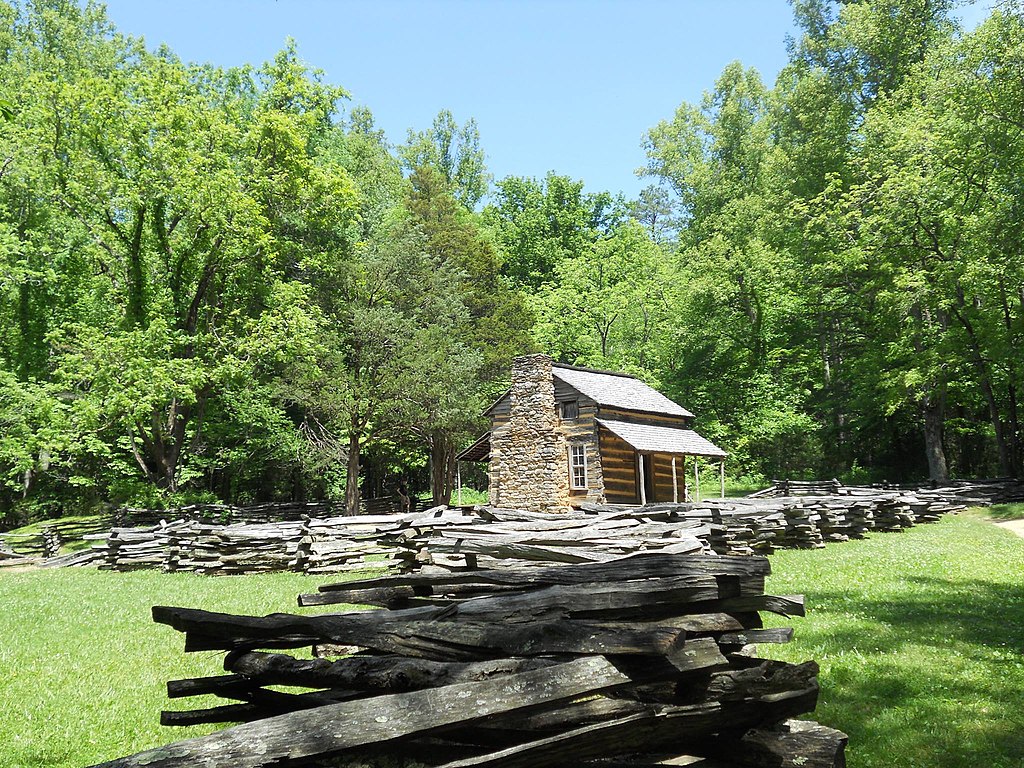 Photo of a 1850s cabin with split-rail fence.