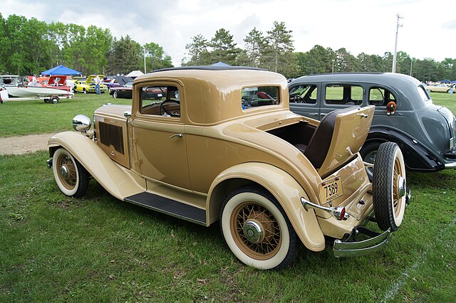 Antique car with rumble seat.