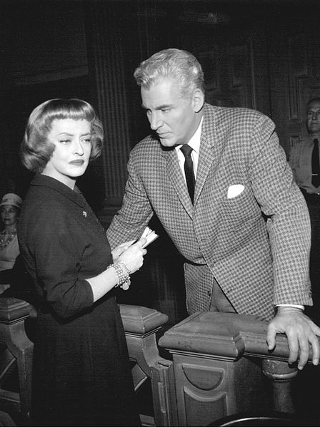 Photo of a man and woman standing in a courtroom.