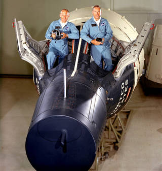 Astronauts standing in Gemini Capsule