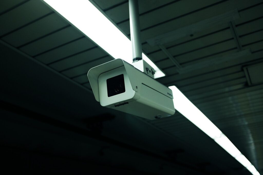 Photo of a surveillance camera in a warehouse.