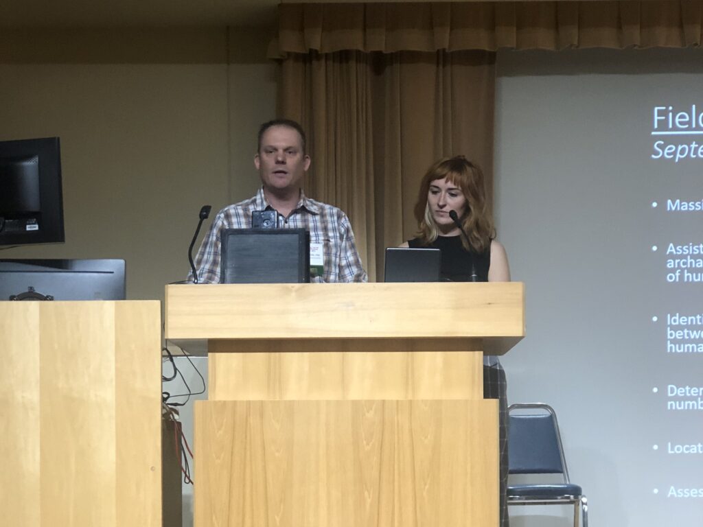 A man and a woman at a podium.