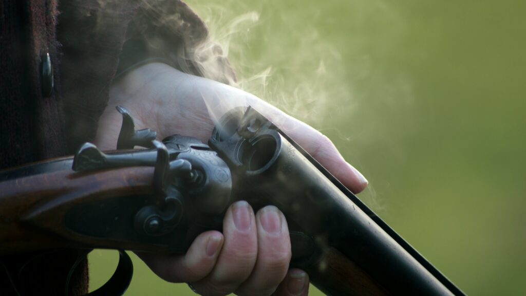 Man holding a double Barrel Shotgun